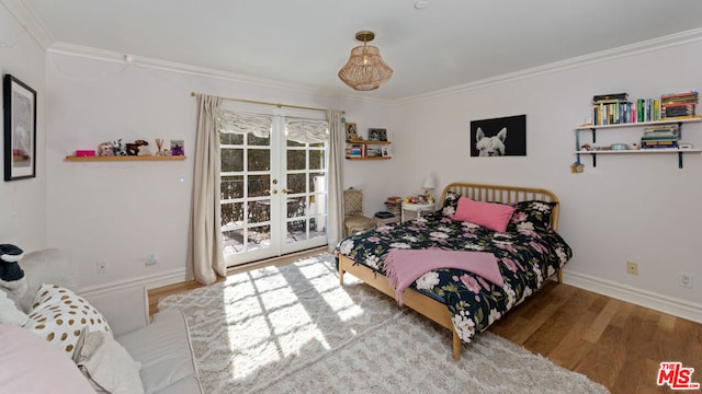 bedroom featuring hardwood / wood-style flooring, crown molding, and french doors