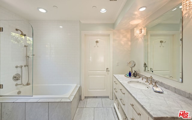 bathroom with vanity, tiled shower / bath combo, and ornamental molding