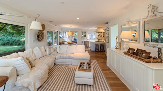 living room with hardwood / wood-style flooring and crown molding