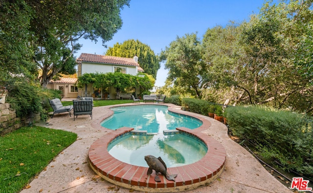 view of swimming pool featuring an in ground hot tub and a patio area