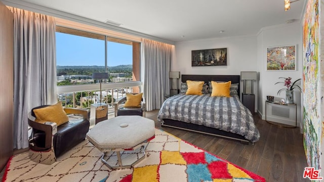 bedroom with expansive windows, ornamental molding, and hardwood / wood-style floors