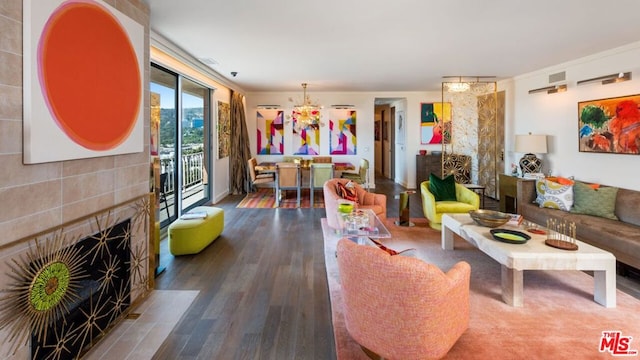 living room featuring dark hardwood / wood-style flooring and a tile fireplace