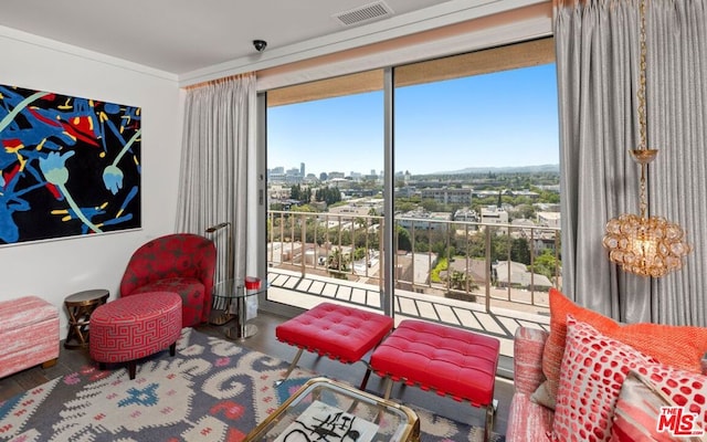 sitting room with a wall of windows and hardwood / wood-style floors