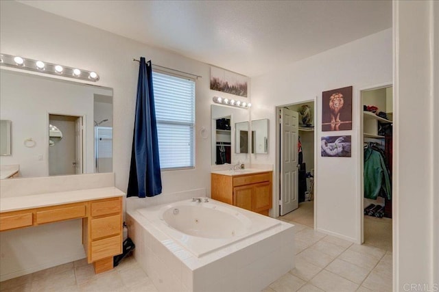 bathroom with vanity, tiled bath, and tile patterned floors