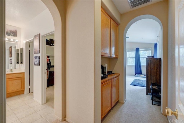 hallway with light colored carpet