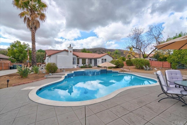 view of swimming pool with a mountain view and a patio area