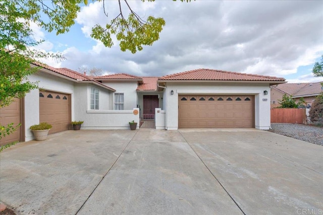 mediterranean / spanish-style home with a garage