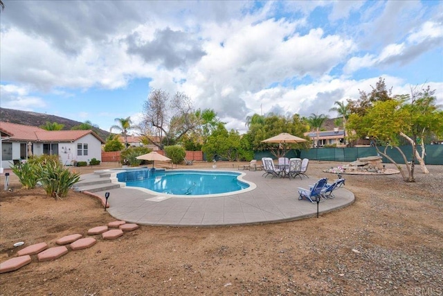 view of swimming pool with a patio