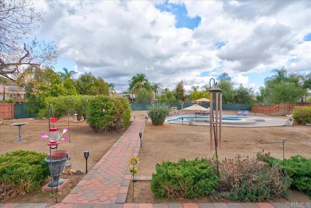 view of jungle gym featuring a fenced in pool and a patio