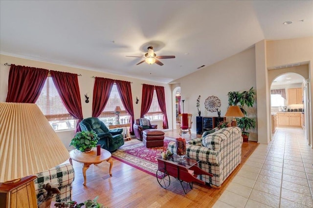 tiled living room with ceiling fan