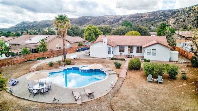 view of pool featuring a mountain view and a patio