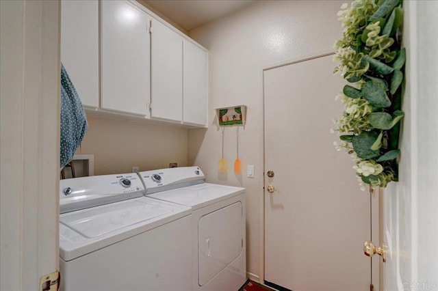 laundry area featuring cabinets and washer and clothes dryer