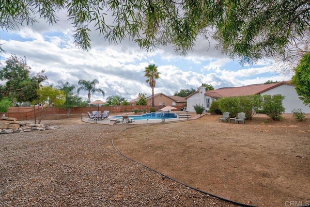 view of yard with a fenced in pool and a patio area