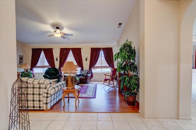 tiled living room featuring ceiling fan