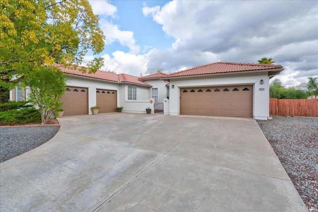 mediterranean / spanish house with a garage