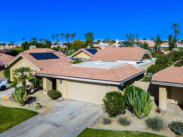 view of front of home featuring a garage and solar panels