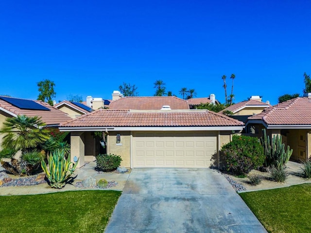 single story home featuring a garage and a front yard