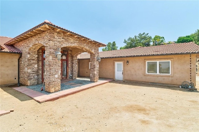 mediterranean / spanish-style house featuring a patio area