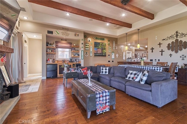 living room with dark hardwood / wood-style floors and beam ceiling