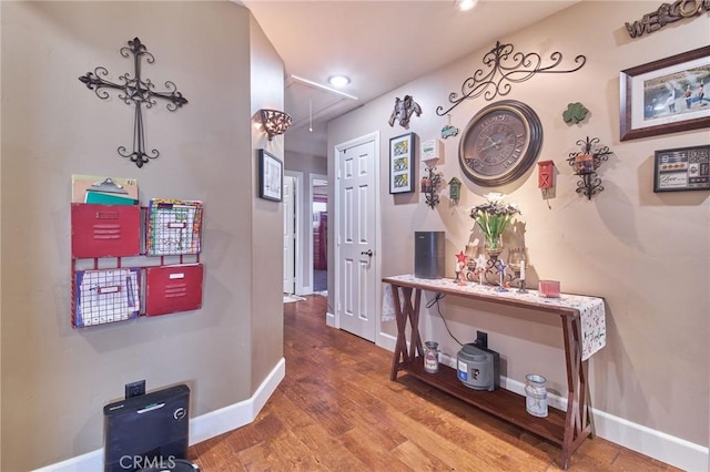 corridor with hardwood / wood-style floors