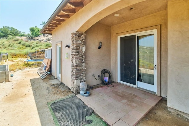 doorway to property with a patio area