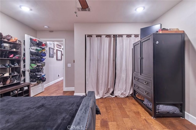 bedroom with ceiling fan and light wood-type flooring