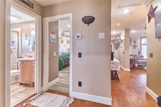 corridor with hardwood / wood-style floors