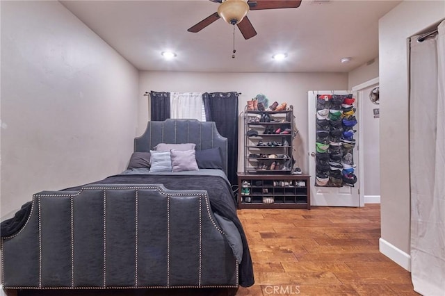 bedroom featuring hardwood / wood-style flooring and ceiling fan