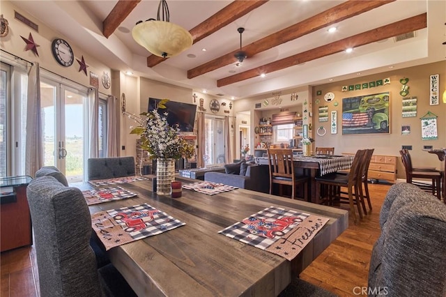 dining space featuring beamed ceiling, dark hardwood / wood-style floors, ceiling fan, and french doors