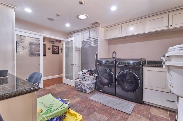 laundry area with cabinets, washer and dryer, and french doors