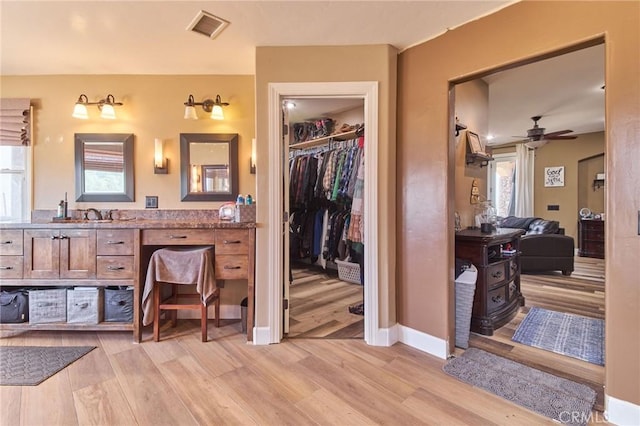 bathroom featuring vanity, hardwood / wood-style floors, and a wealth of natural light