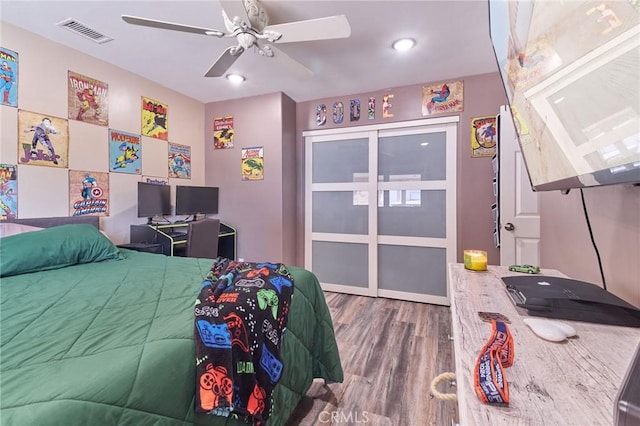 bedroom with hardwood / wood-style flooring and ceiling fan