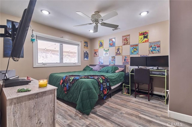 bedroom with ceiling fan and hardwood / wood-style floors