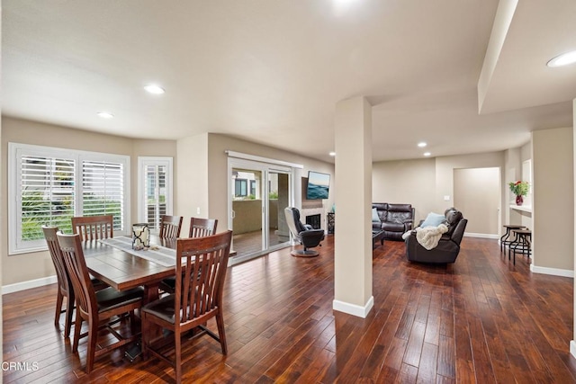 dining space with dark wood-type flooring and plenty of natural light