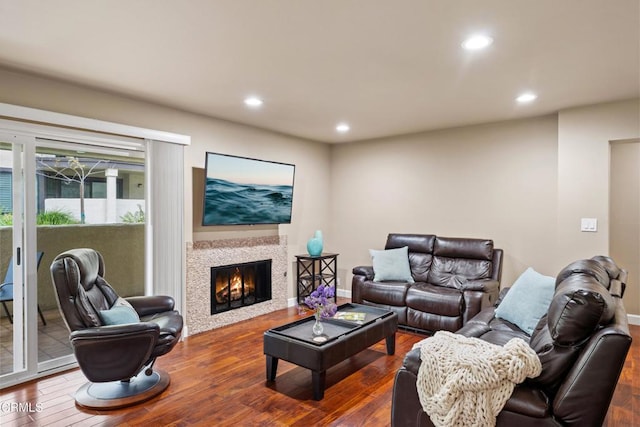 living room featuring dark hardwood / wood-style floors and a tile fireplace