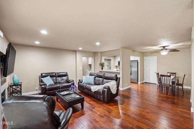 living room with dark hardwood / wood-style floors and ceiling fan