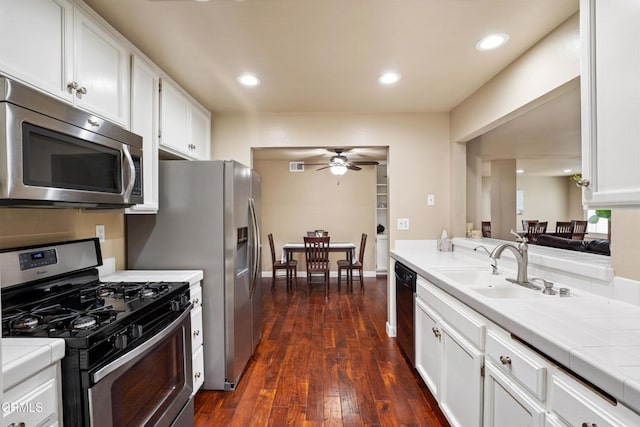 kitchen featuring sink, white cabinetry, dark hardwood / wood-style floors, ceiling fan, and stainless steel appliances