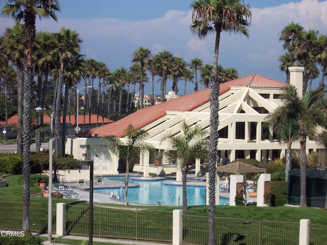 view of swimming pool with a patio and a lawn