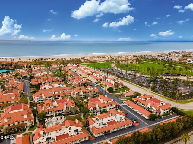 bird's eye view featuring a water view and a beach view