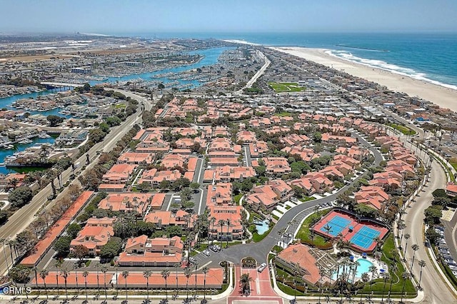 drone / aerial view with a beach view and a water view