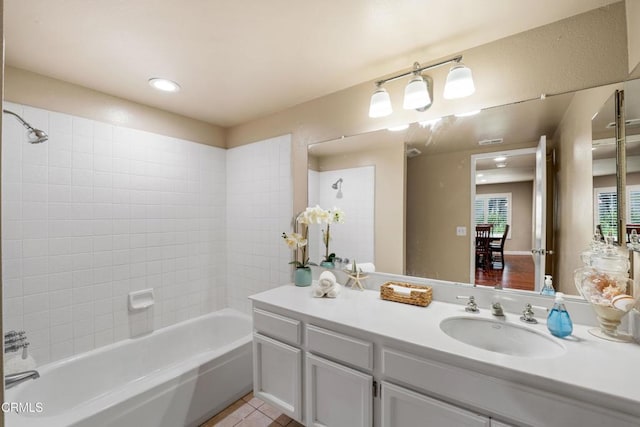 bathroom featuring vanity, tiled shower / bath combo, and tile patterned floors