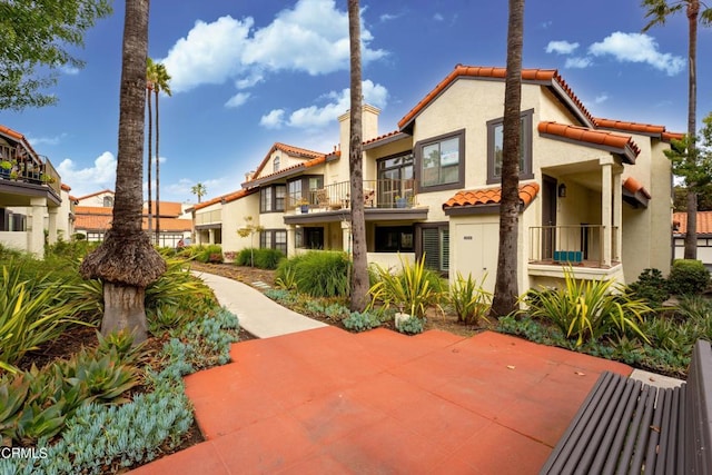 back of property with a balcony