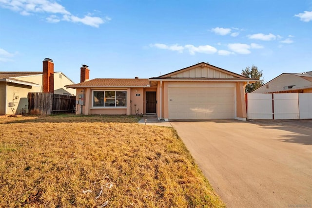 ranch-style house featuring a garage and a front lawn