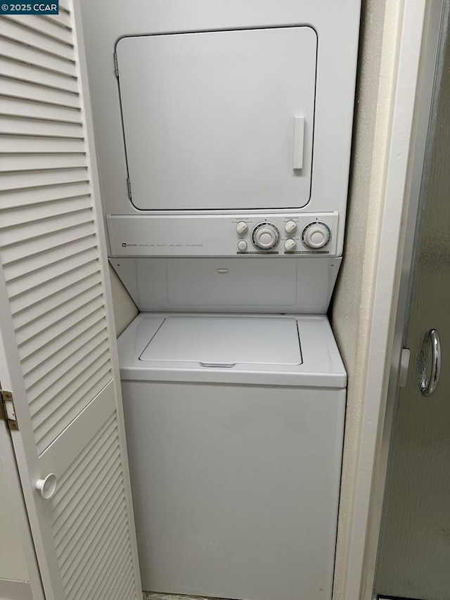 laundry room featuring stacked washer / dryer