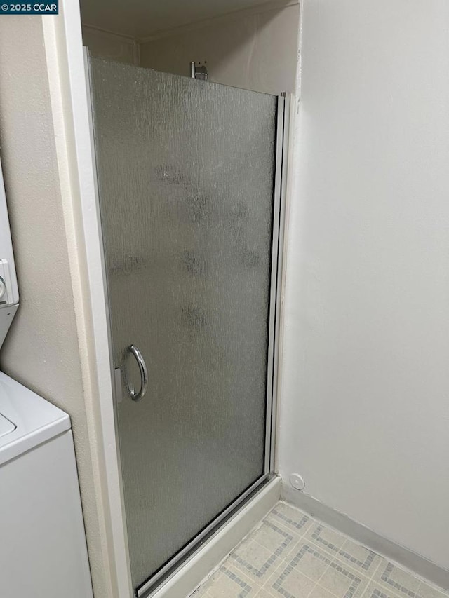 bathroom featuring a shower with door