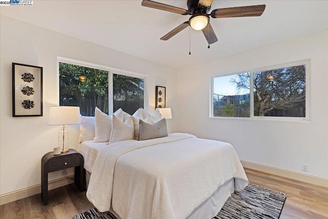 bedroom featuring hardwood / wood-style flooring and ceiling fan