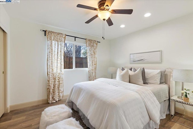 bedroom with hardwood / wood-style flooring and ceiling fan