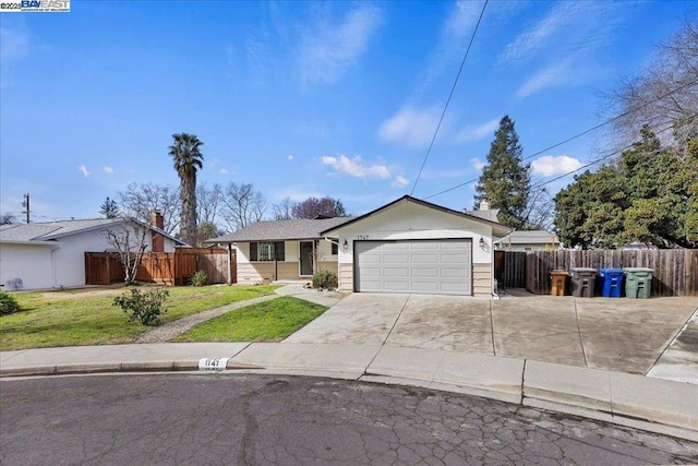 ranch-style home with a garage and a front lawn