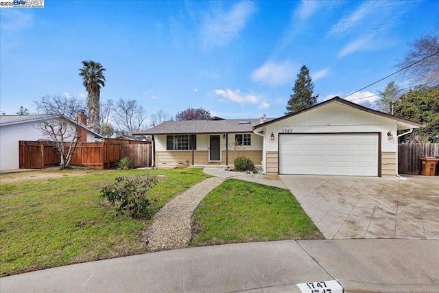 ranch-style home featuring a garage and a front lawn