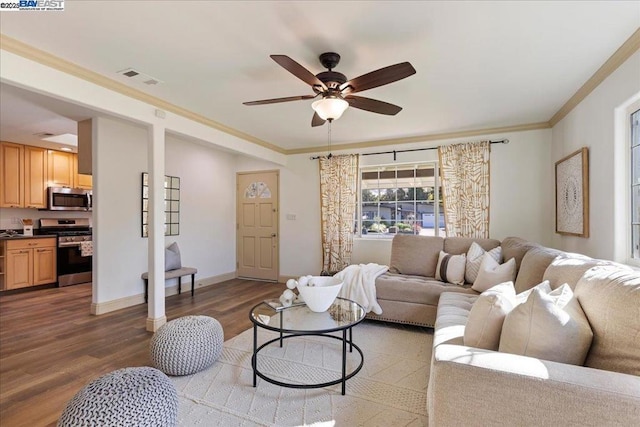 living room featuring ornamental molding, dark wood-type flooring, and ceiling fan